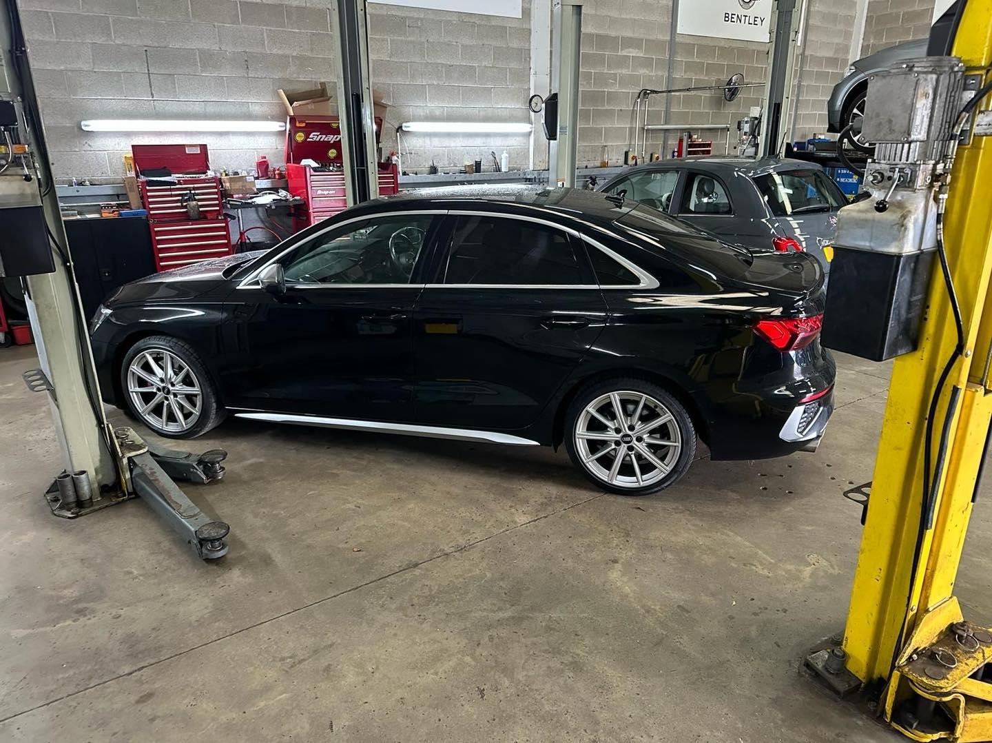 Audi technician performing vehicle inspection at Mitsiland Manchester